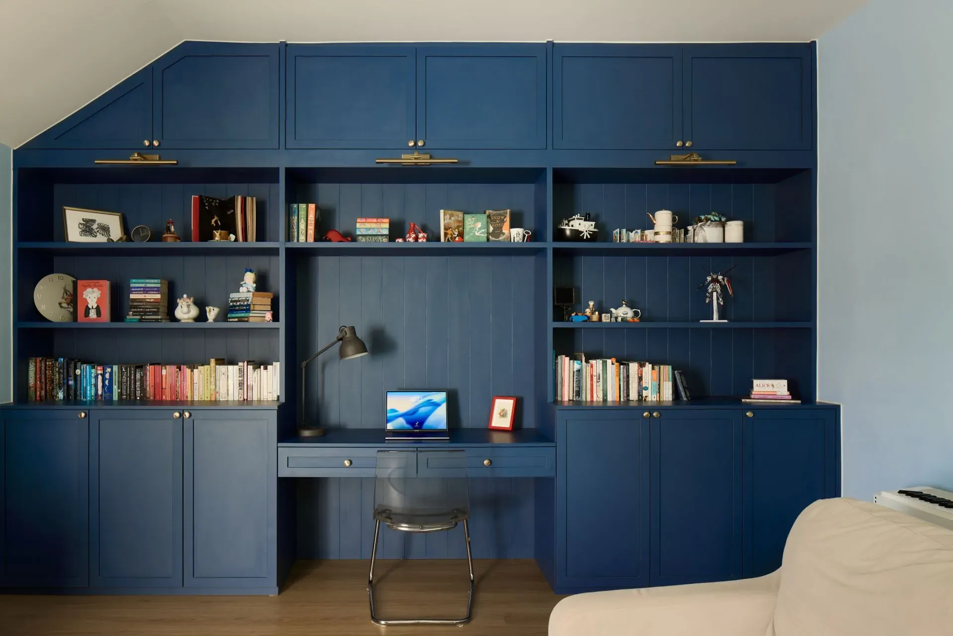 Cozy home office with blue bookshelves and desk.