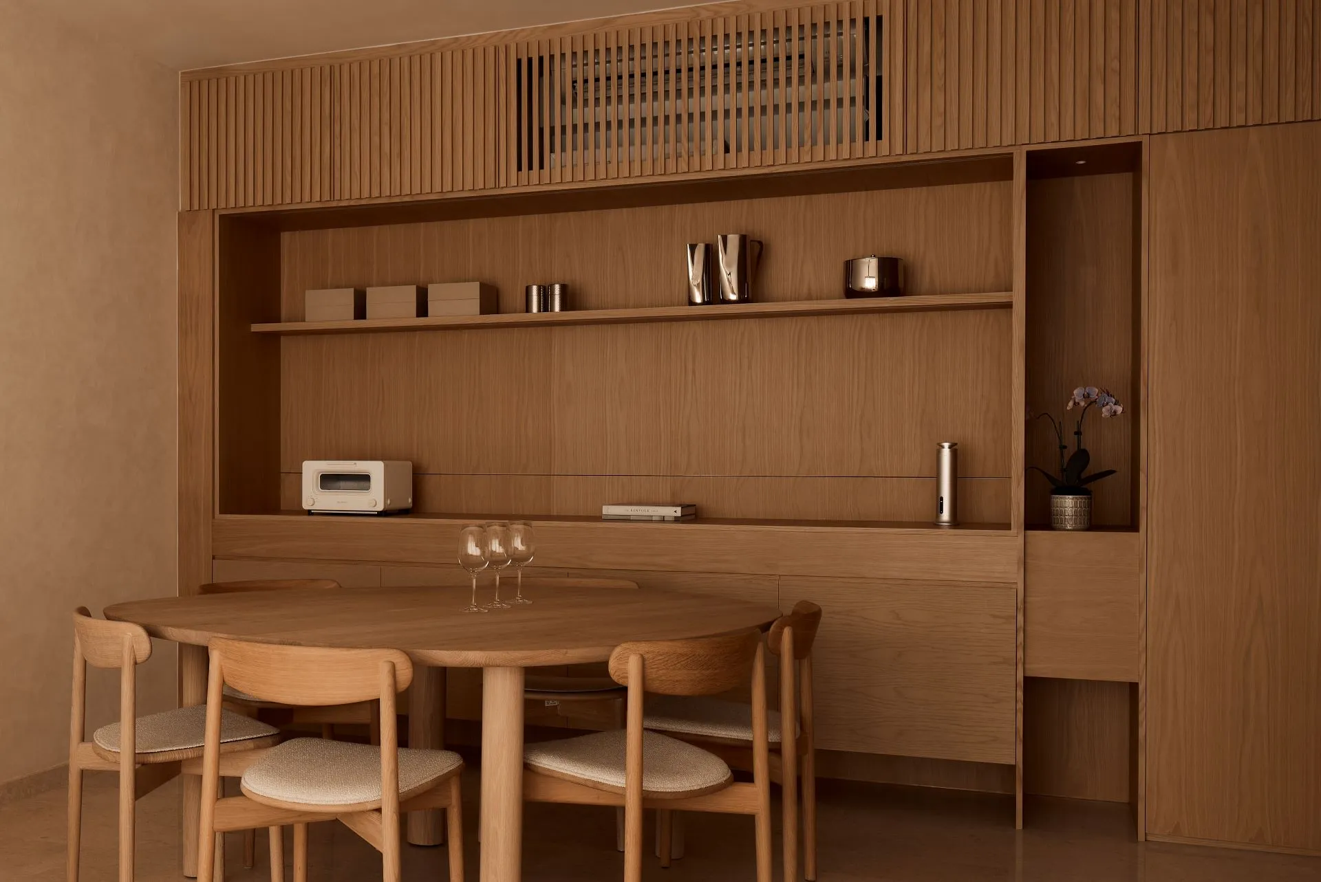 Minimalist wooden dining room with table and chairs.